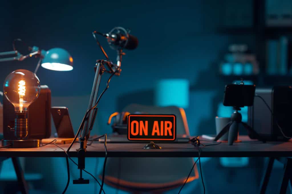 how-to-generate-revenue-from-your-podcast01-1024x683-1 Live online radio studio with on air sign
